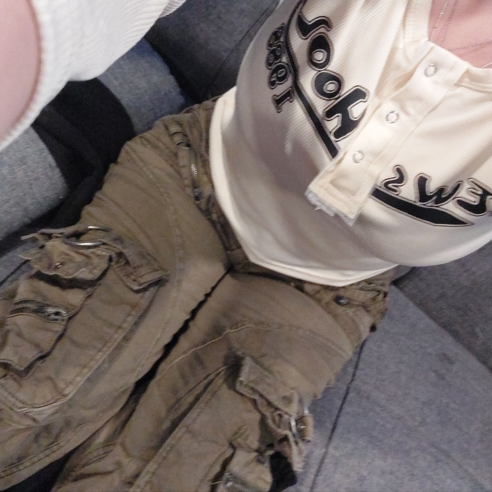 Green cargo pants and a white crop tee